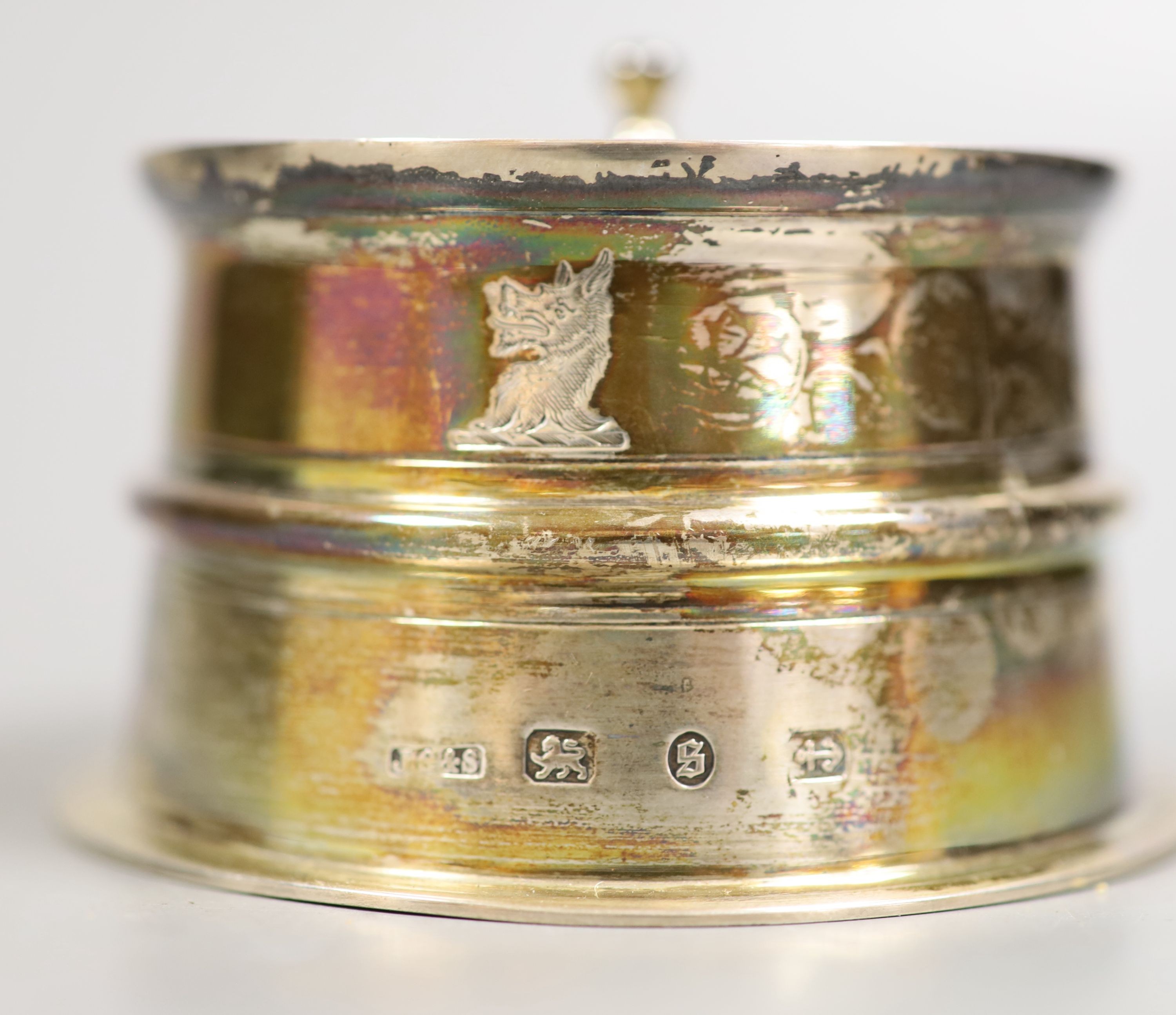 A late Victorian silver mounted glass circular desk inkwell, with domed cover and five pen holes, John Grinsell & Sons, Birmingham, 1892, height 52mm.